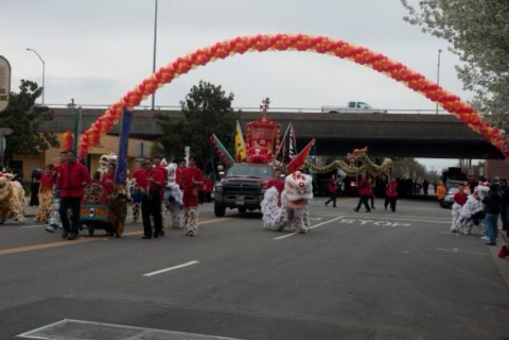 A white dragon leads a Dodge Ram that has a red structure on top in Stockton's 2010 Chinese New Year parade.