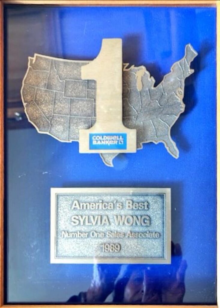 A plaque honoring Sylvia Wong as America's Best and Number One Sales Associate in 1989