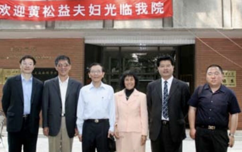 Henry and Sylvia Wong with four representatives of Tsinghua University in front of the Henry Y.T. Wong Building.